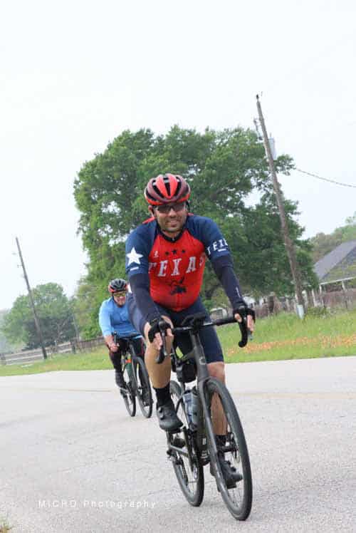 Riders cycling on the road with Bluebonnet Express bike services in Texas.