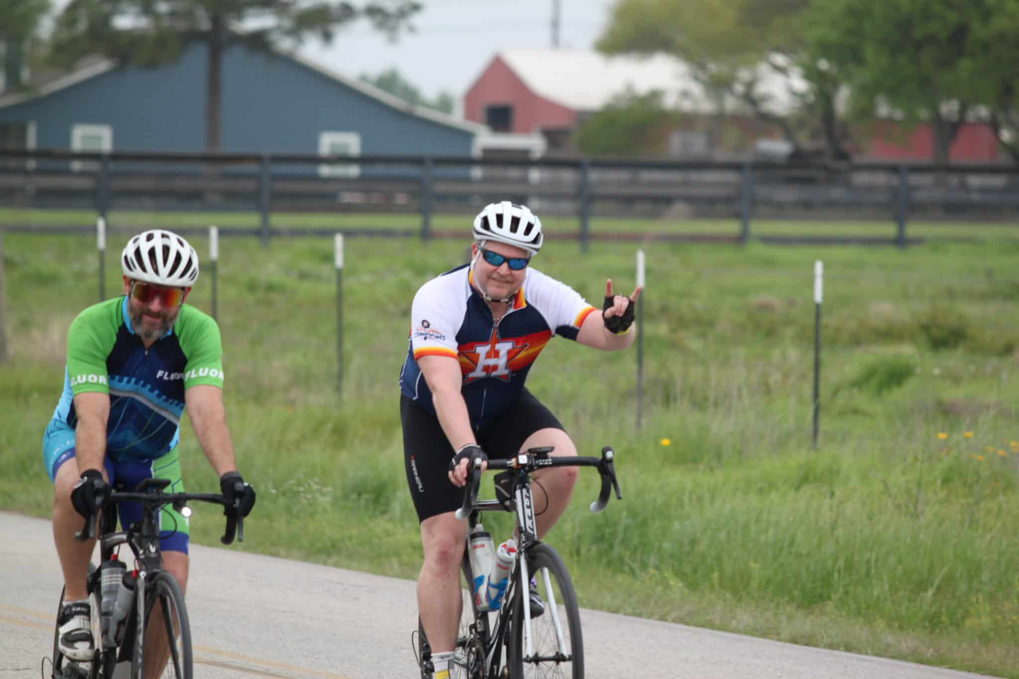 Vibrant cyclists riding on a scenic outdoor trail, promoting Bluebonnet Express bike share program.
