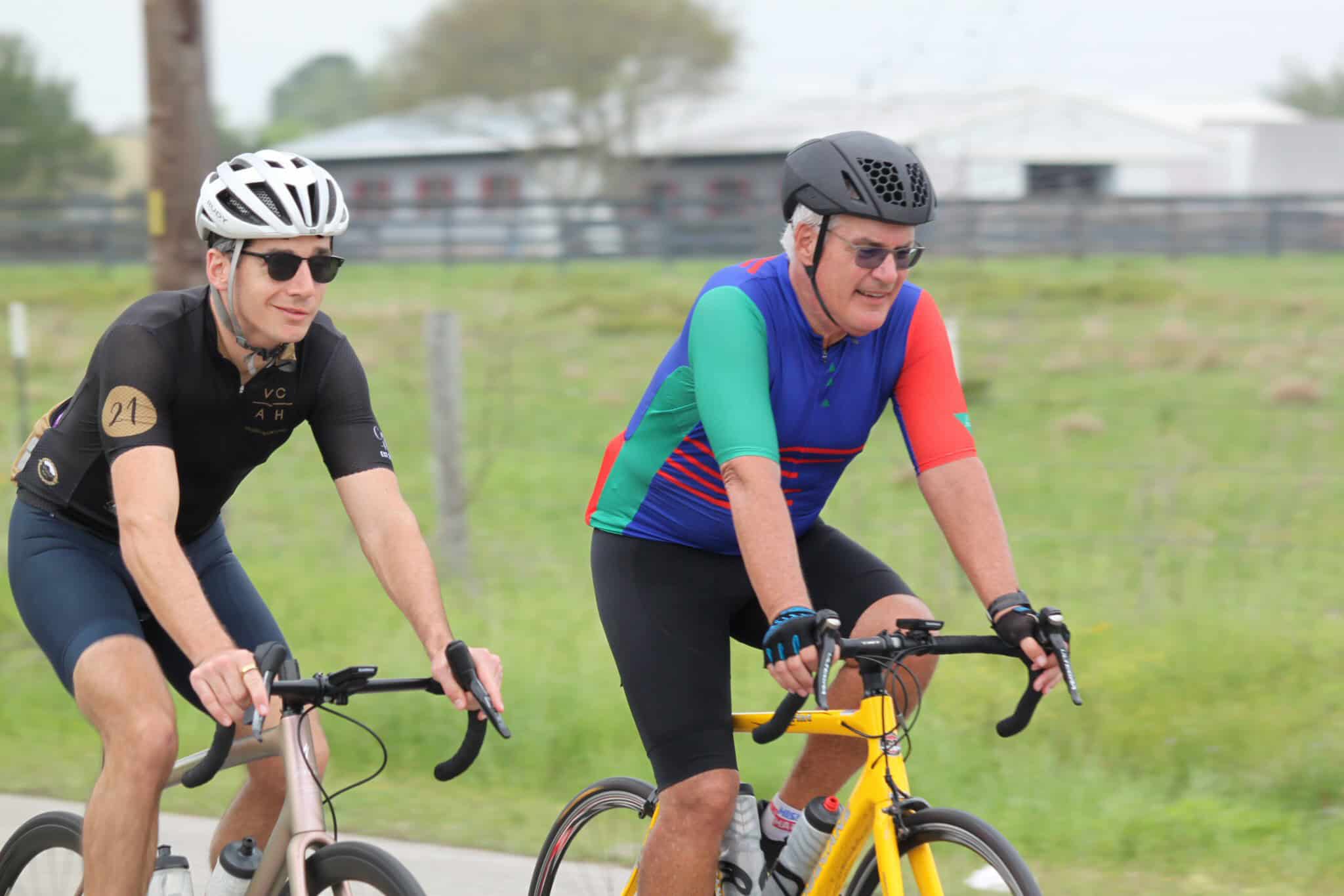 Vibrant cyclists riding on a scenic bike trail for Bluebonnet Express event.