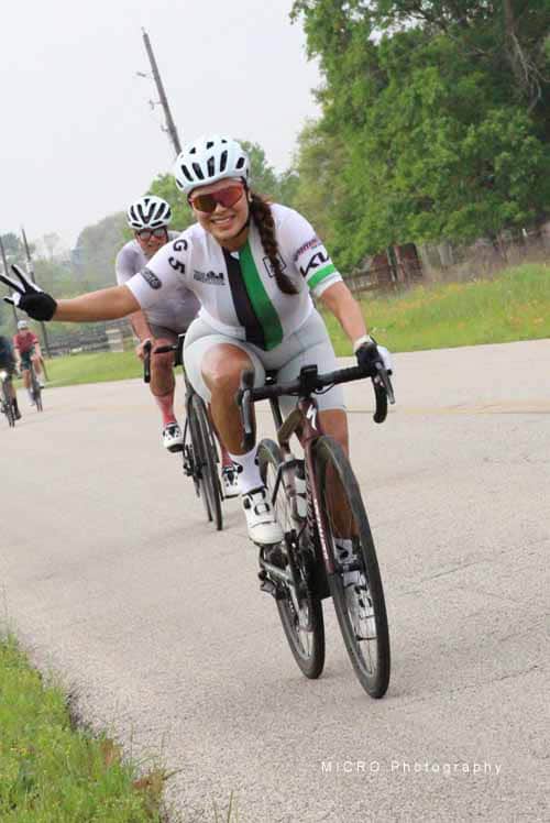Bright female cyclist enjoying the Bluebonnet Express ride on a scenic outdoor trail.