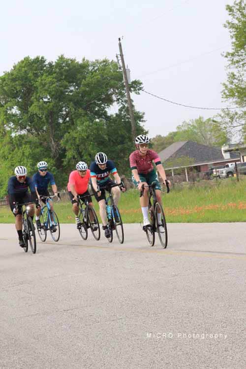 Cyclists riding together on a scenic route in Texas for Bluebonnet Express event.