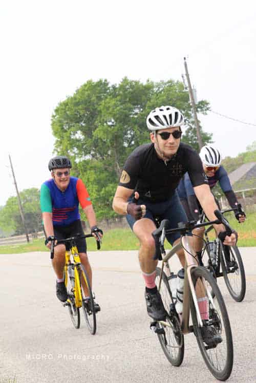 Vibrant cyclists riding on a scenic outdoor route during Bluebonnet Express event.