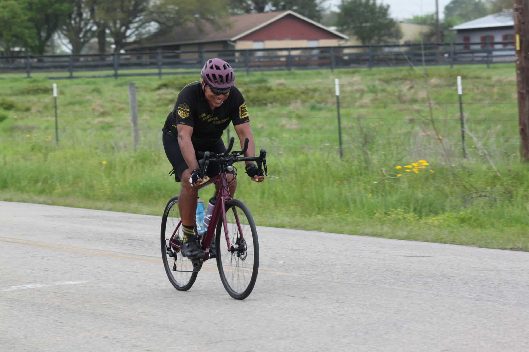 High-performance cyclist riding a road bike on the Bluebonnet Express route.