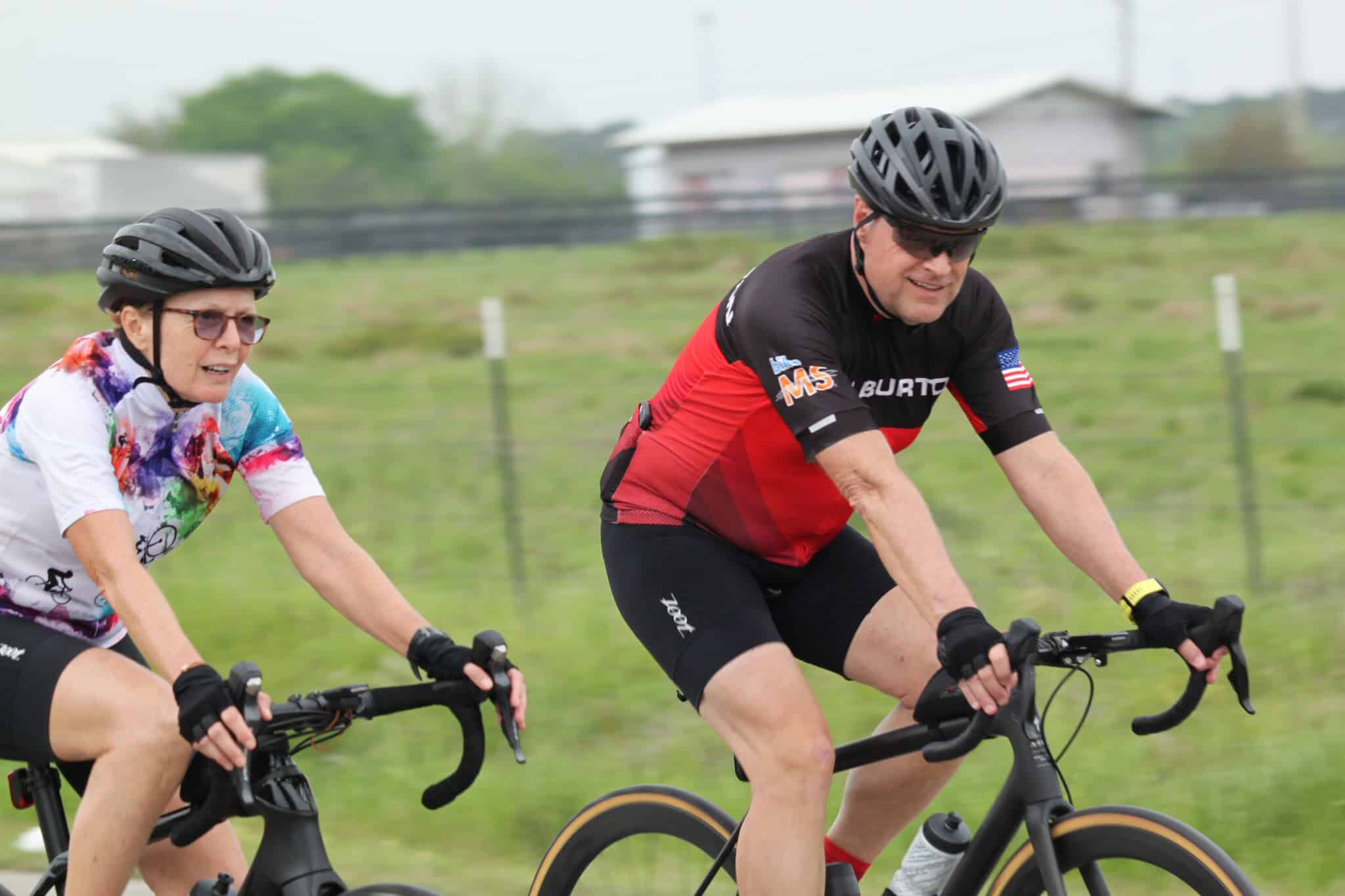 Vibrant cyclists enjoying the scenic Bluebonnet Express bike ride on a cloudy day.