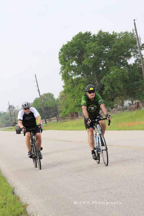 Bike riders on scenic country road for Bluebonnet Express event.
