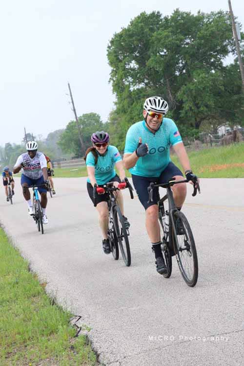 Bright group cycling during Bluebonnet Express event on rural Texas roads, promoting healthy outdoor activities.