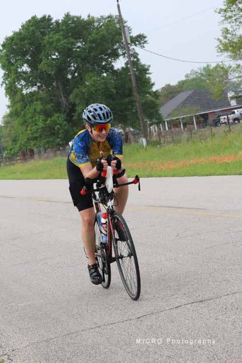 Bike rider enjoying a scenic route with Bluebonnet Express biking gear.