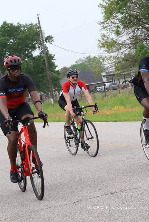 Cyclists riding during Bluebonnet Express cycling event in Texas, supporting charity and outdoor fitness.