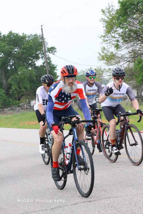 Bike riders in patriotic jerseys participating in Bluebonnet Express cycling event.