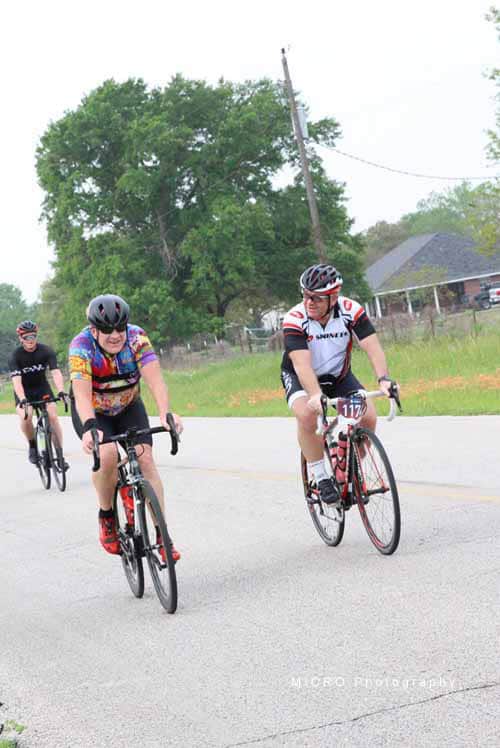 1. Cyclists riding on a rural road during Bluebonnet Express event.