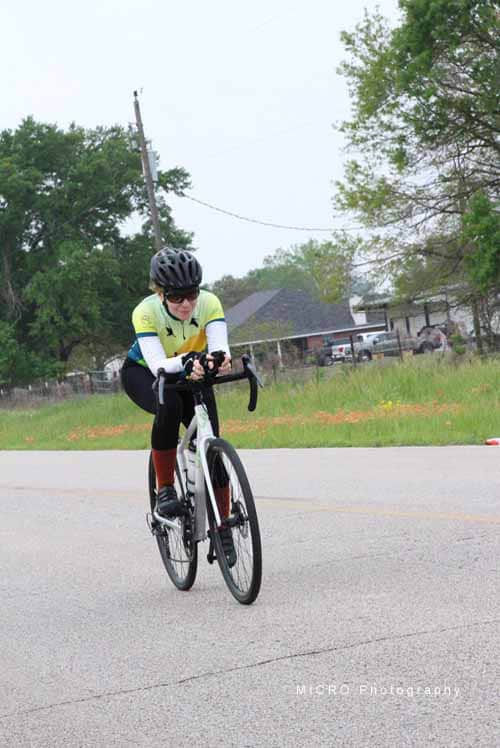 Bright cyclist riding on the road for Bluebonnet Express event.