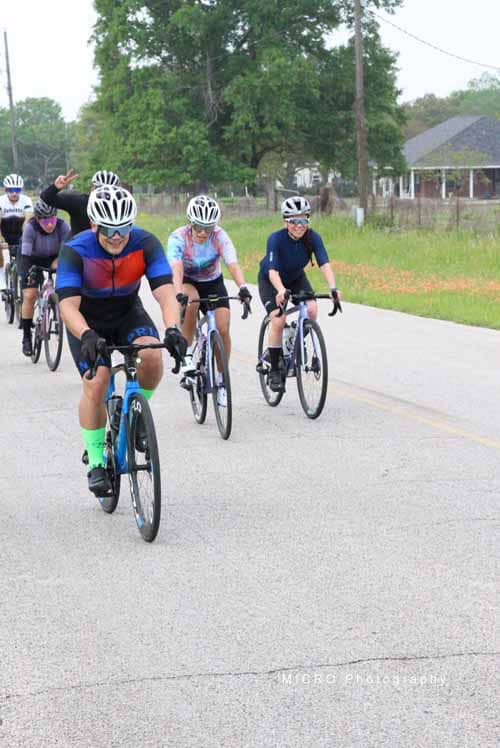 Riders on bicycles participating in Bluebonnet Express cycling event, outdoor group ride, Texas.