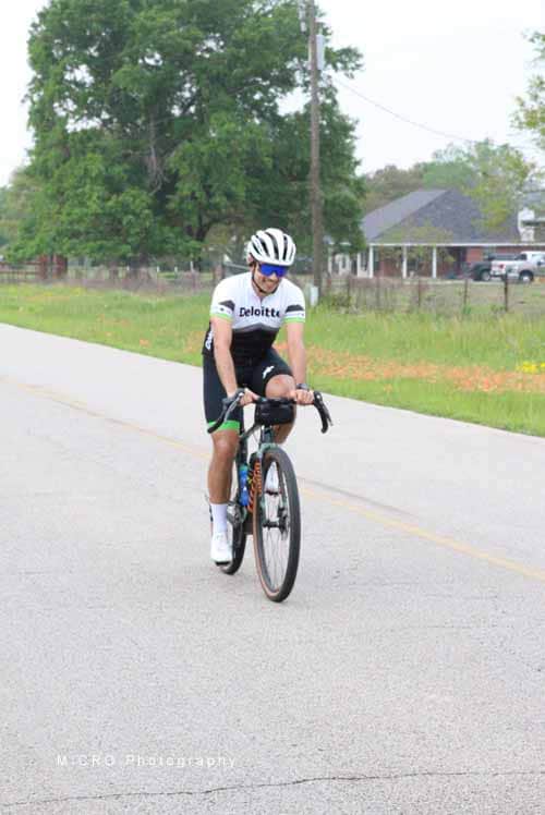 Bright cyclist riding during Bluebonnet Express event in Texas countryside, showcasing outdoor biking and health.