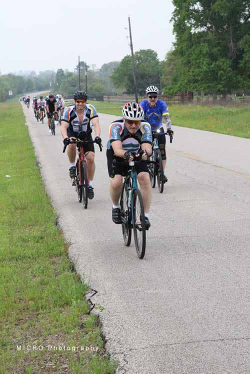 Enjoying a group cycling ride along scenic rural roads during Bluebonnet Express event.