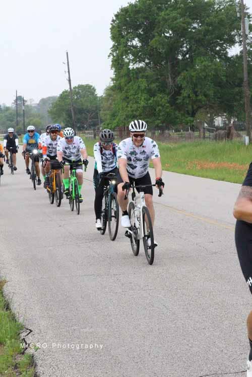 Group of cyclists riding on the road during Bluebonnet Express event in Texas, outdoor biking, cycling race, scenic route.