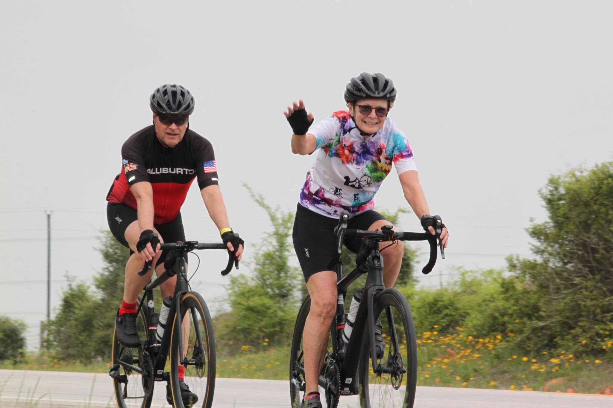 Cyclists riding together on a scenic bike ride with Bluebonnet Express branding.