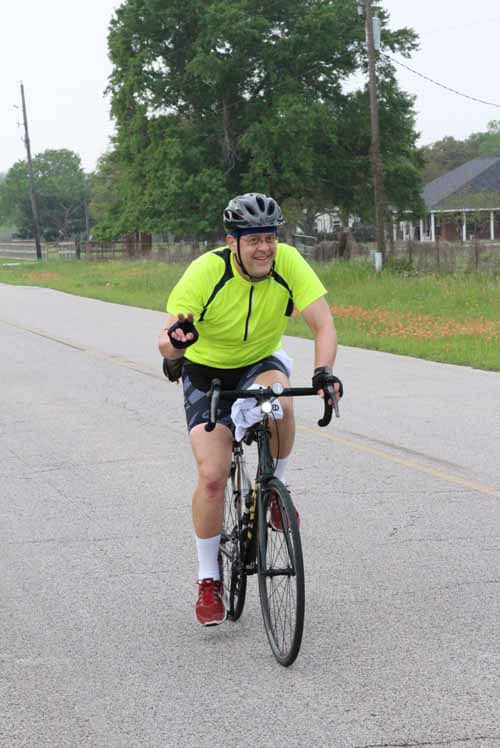 Bright yellow Cycling jersey, smiling cyclist, on-road riding, outdoor exercise, Bluebonnet Express.