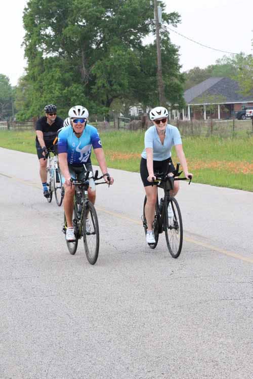 Cycling group on rural road enjoying Bluebonnet Express bike ride event.
