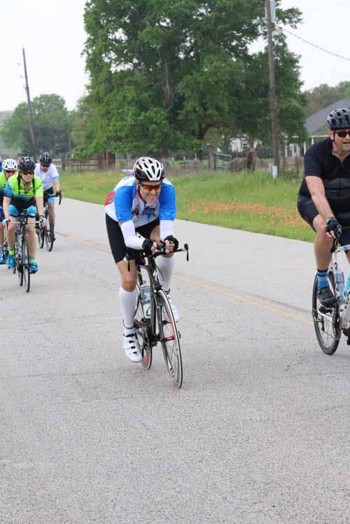 Cyclists riding together on a scenic road during Bluebonnet Express event.