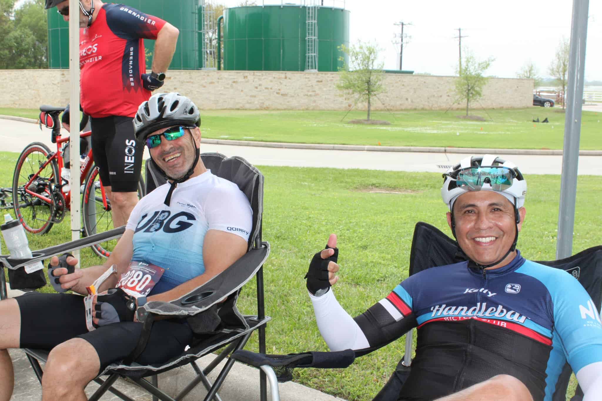 Enjoying a break at Bluebonnet Express cycling event with friends, showcasing cycling gear and community spirit.
