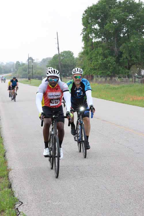 Brightly dressed cyclists enjoying a scenic ride during Bluebonnet Express event.
