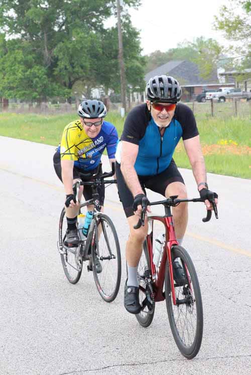 1. Happy cyclists riding on a scenic trail during daytime, enjoying Bluebonnet Express ride.