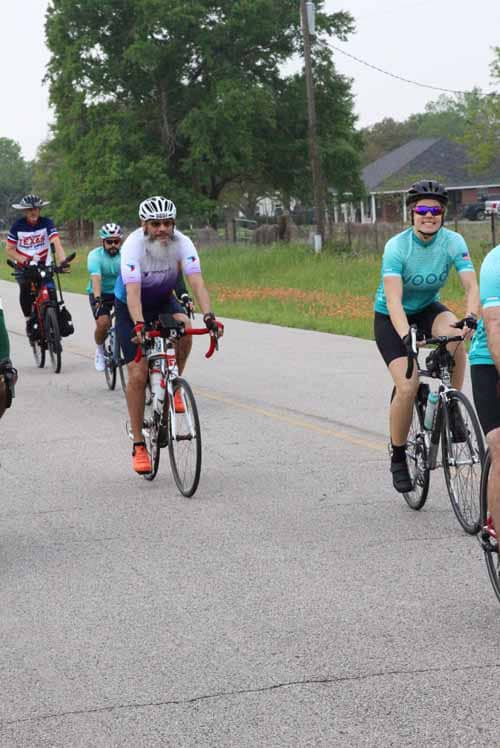 1. Bicyclists riding along rural road during Bluebonnet Express event.