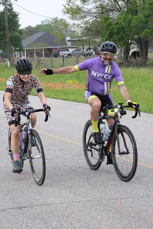 High-quality image of a man and a girl riding bicycles on the road, promoting family-friendly cycling around Bluebonnet Express.