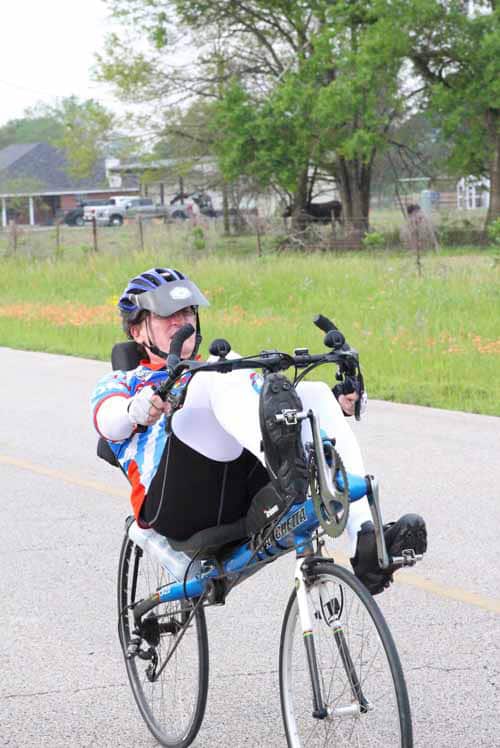 Child riding a bicycle with a helmet on during daytime.