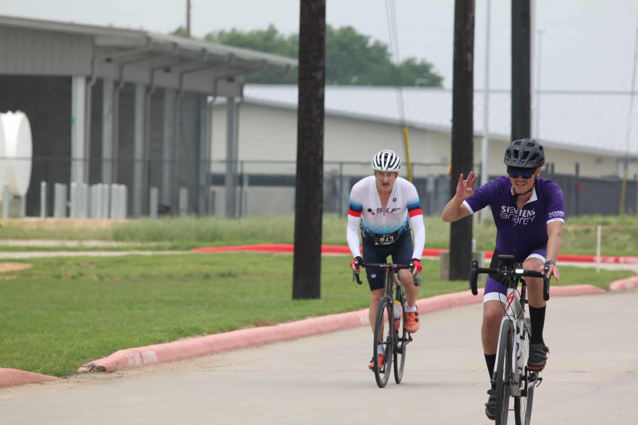 High-performance cyclists riding on a paved trail during a biking event.