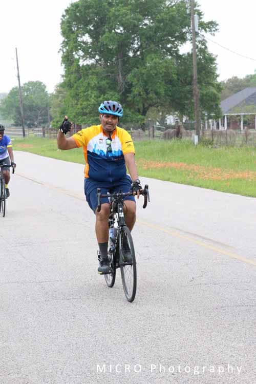 Cyclist riding on road during Bluebonnet Express event.