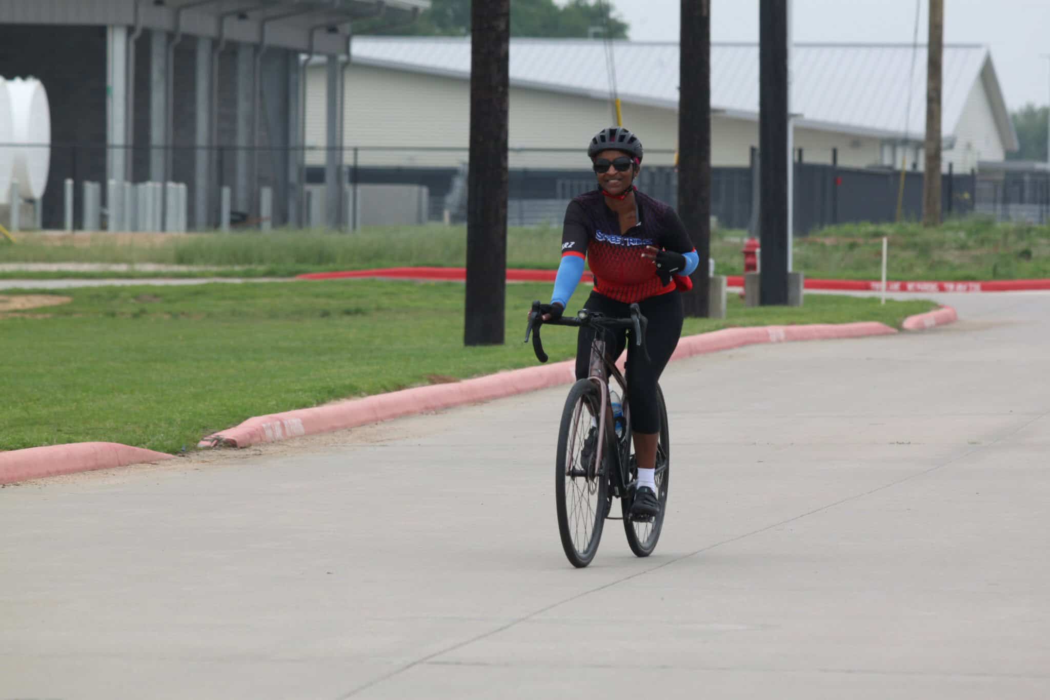 Smooth cycling on the Bluebonnet Express bike trail with a smiling rider enjoying outdoor fitness.