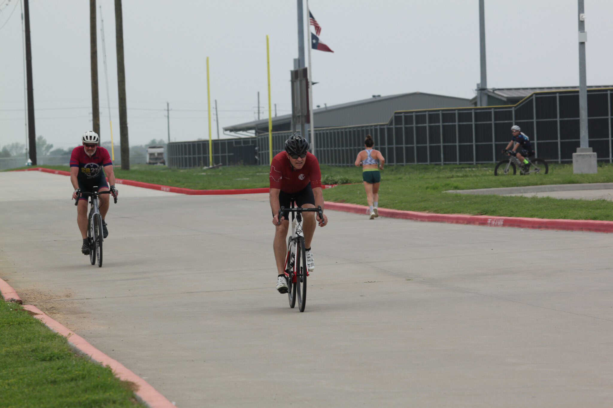 Highway cyclists riding bikes at Bluebonnet Express, Texas, race event.