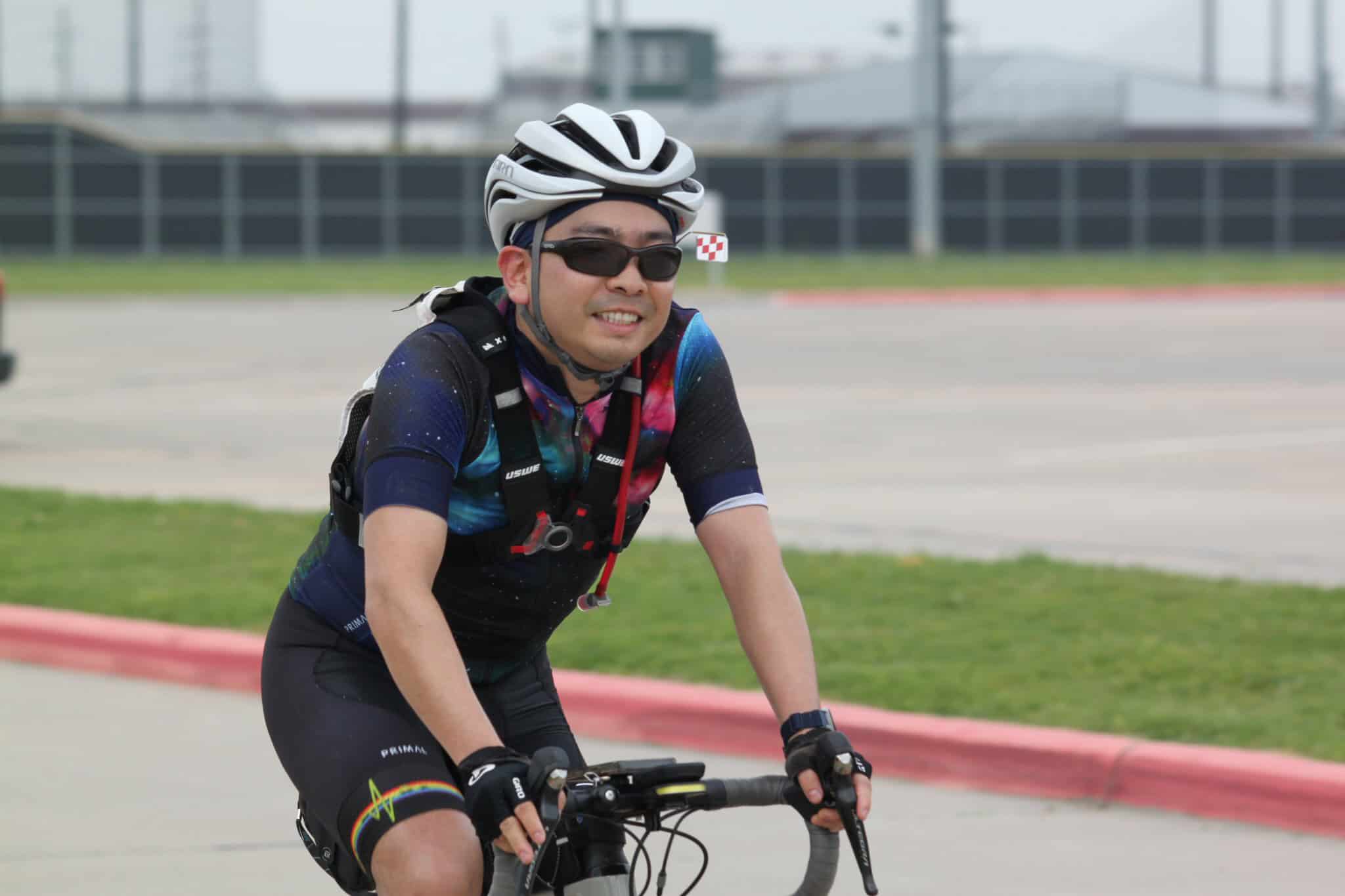 Vibrant cyclist riding on the road during Bluebonnet Express event, showcasing outdoor cycling passion.