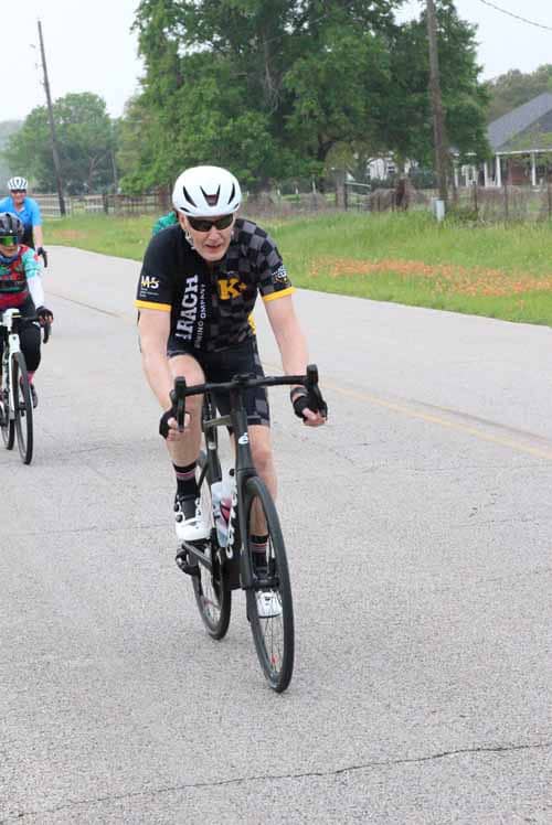 High-performance cyclist wearing helmet and sunglasses during Bluebonnet Express ride.