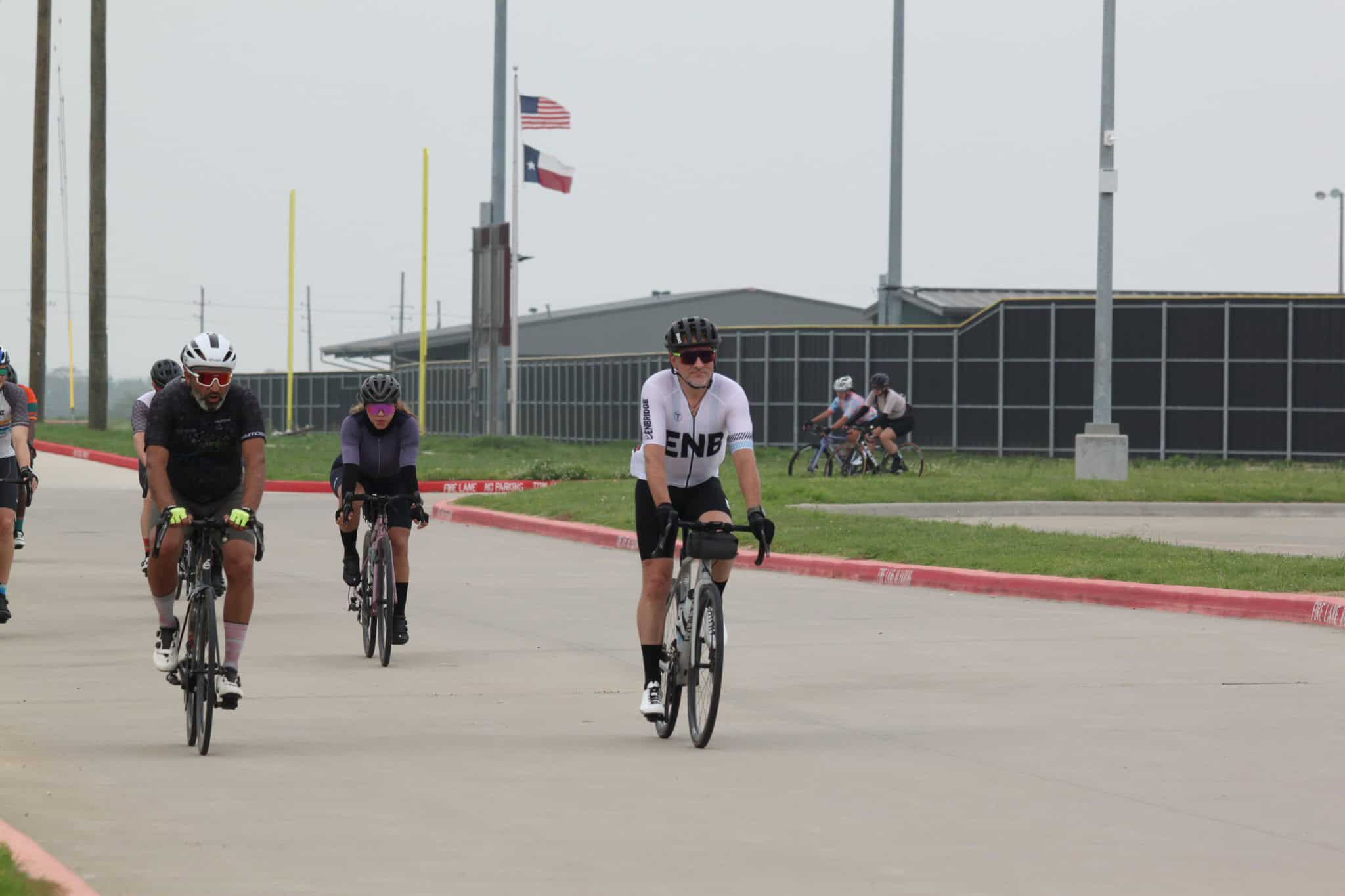 Cyclists riding on a paved road during Bluebonnet Express cycling event in Texas.