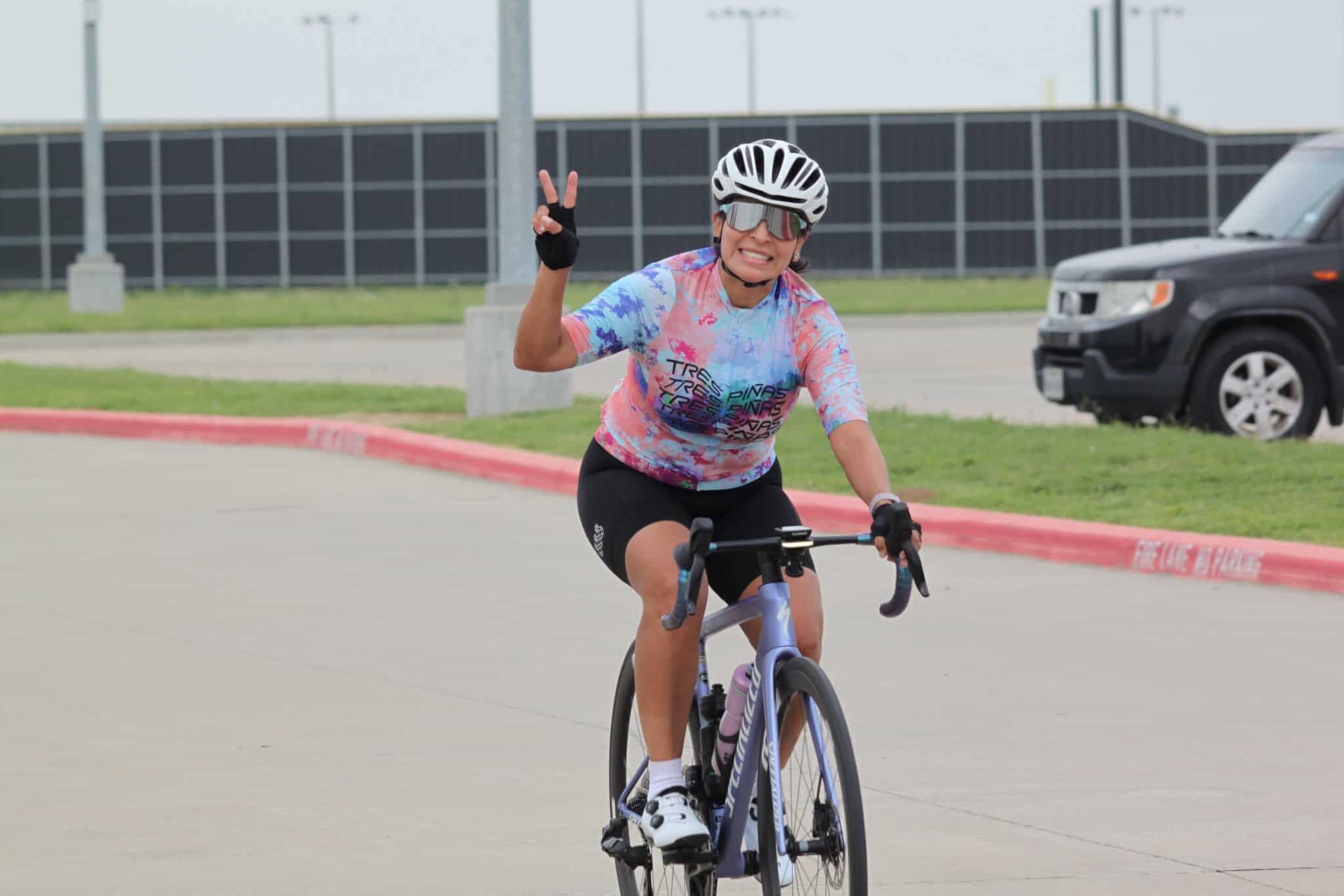 Vibrant cyclist celebrating during Bluebonnet Express bike race, promoting outdoor biking events and fitness.