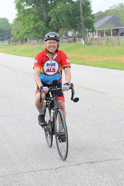 Bright cyclist smiling during Bluebonnet Express charity ride.