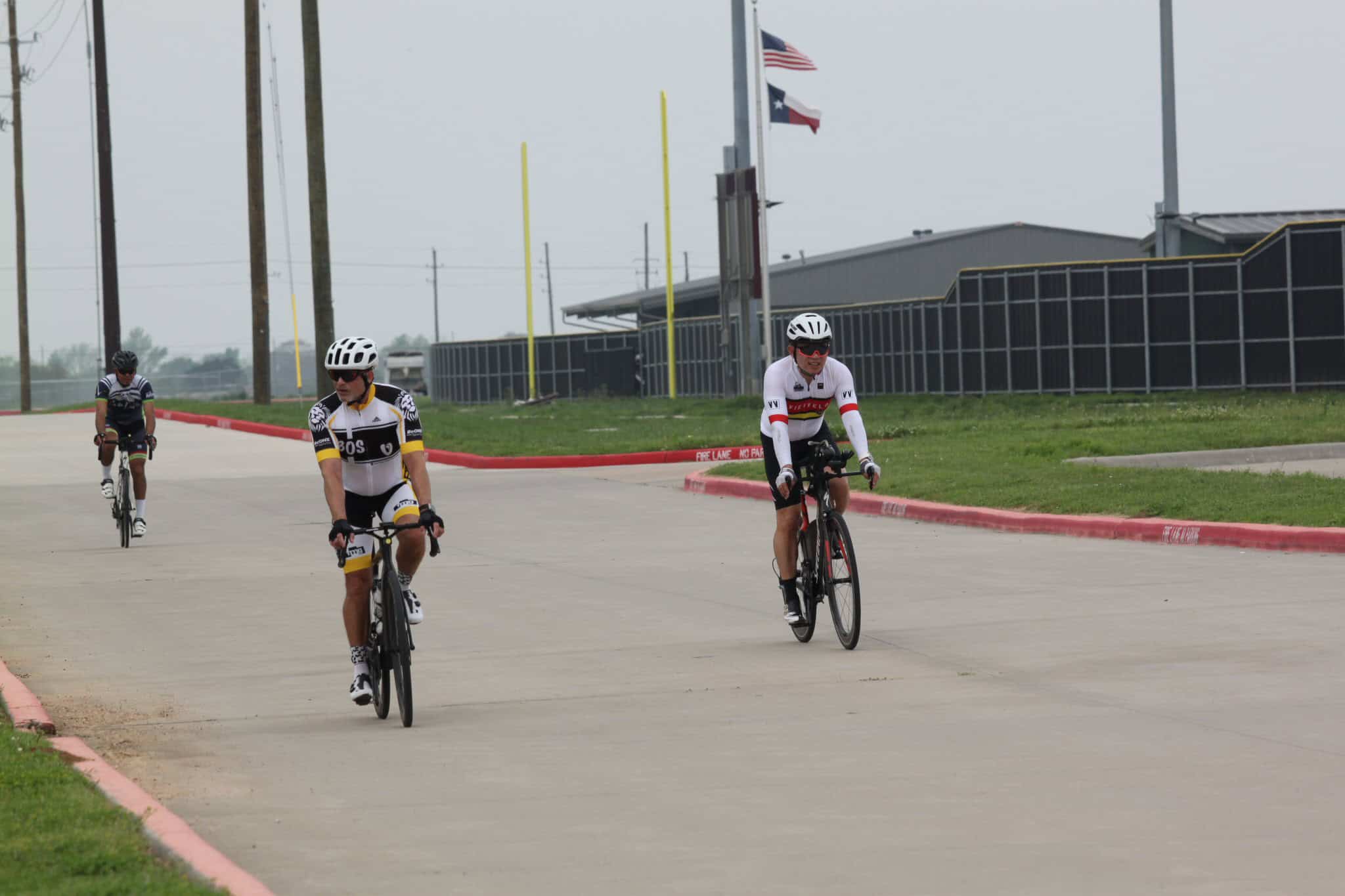 Quiet road cycling with group riders on Texas-style trail at Bluebonnet Express.