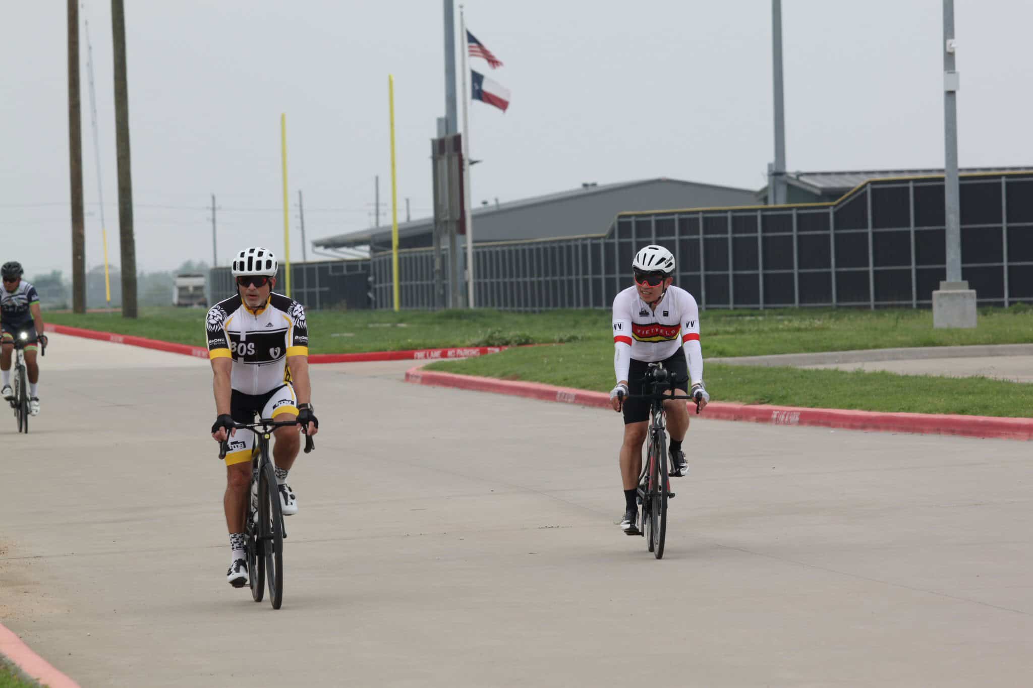 Riders on bicycles enjoying bike ride at Bluebonnet Express event, cycling in team gear.