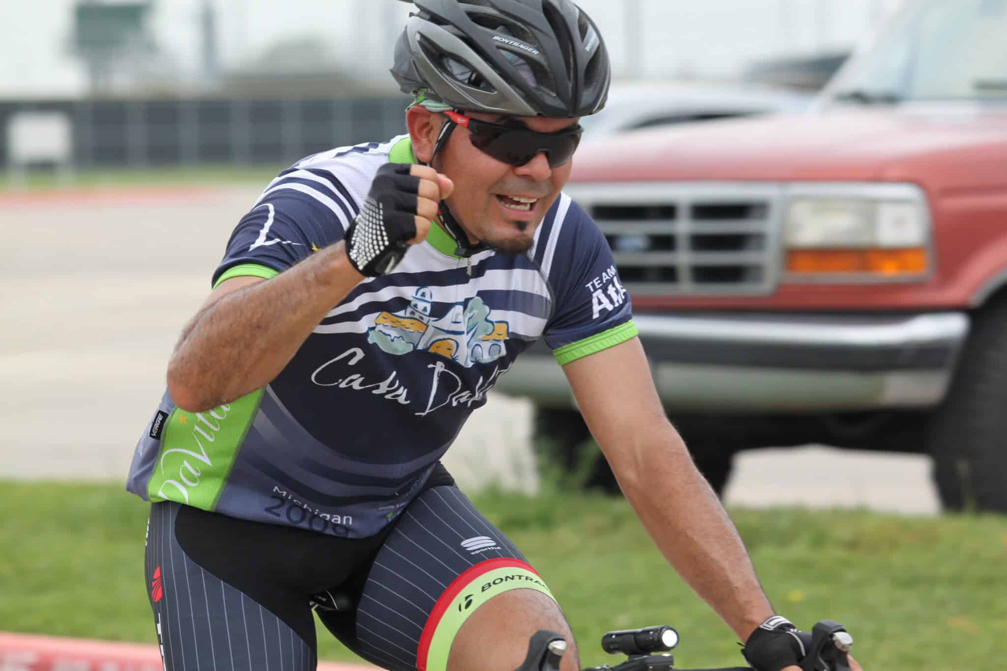 Vibrant cyclist celebrating during Bluebonnet Express cycling event outdoors.