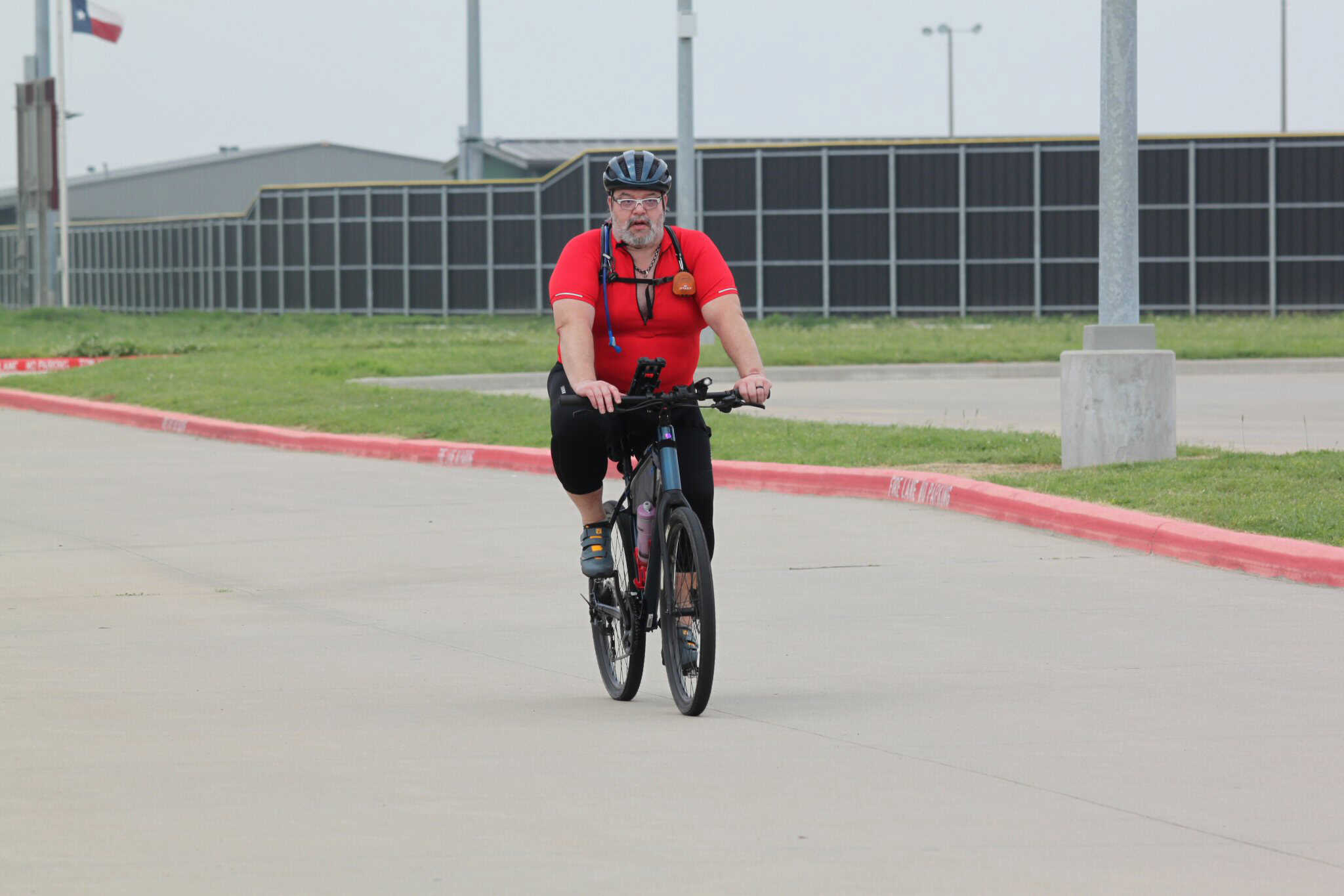 Quiet electric bike rider on a city street, Bluebonnet Express bicycle, community cycling, eco-friendly transportation.