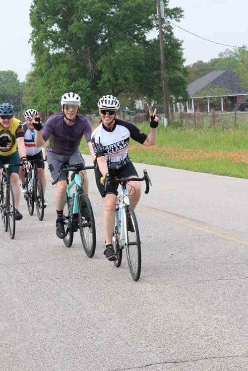 Bright group of cyclists participating in Bluebonnet Express cycling event, promoting outdoor fitness and community.