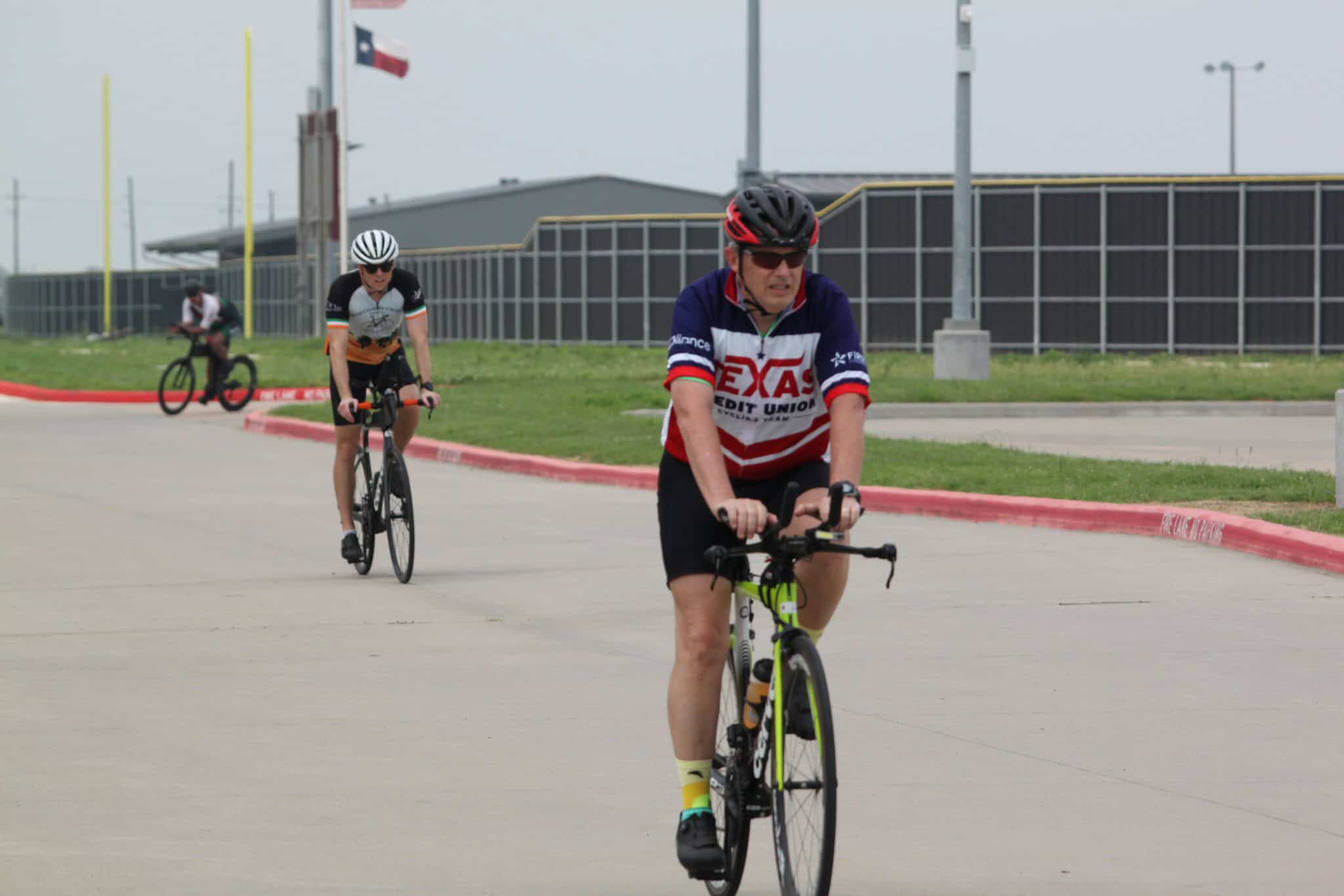 Bright bluebonnet express cycling event with cyclists on the road in Texas.