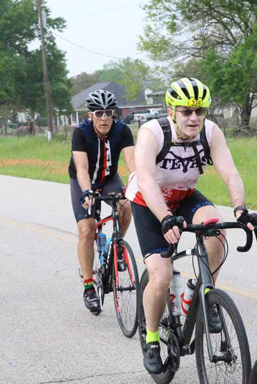 Bike riders on a rural road participating in Bluebonnet Express cycling event.