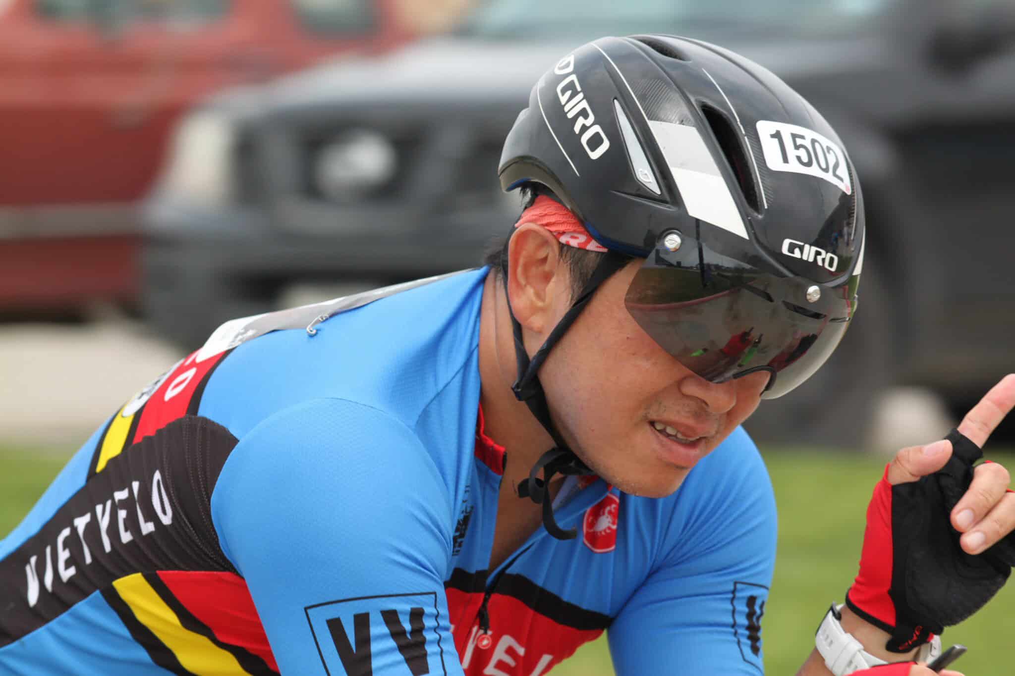 Bike racing cyclist wearing Giro helmet and blue jersey, participating in Bluebonnet Express event.