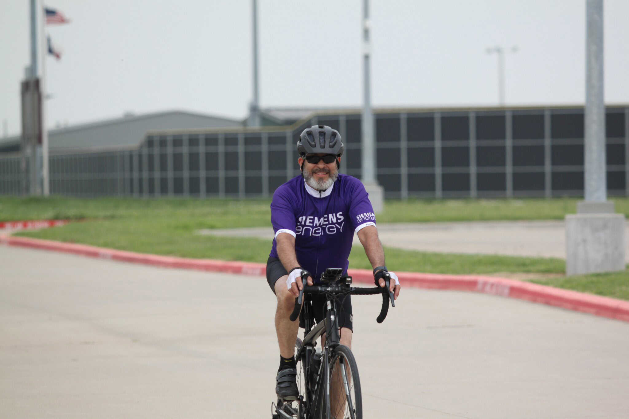 Optimized bike rider in Siemens Energy cycling jersey for Bluebonnet Express event.