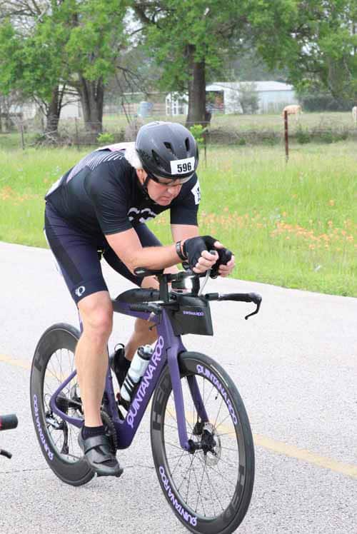 Rider in cycling race on Aquanator bike during Bluebonnet Express event, outdoor race, and cycling competition.