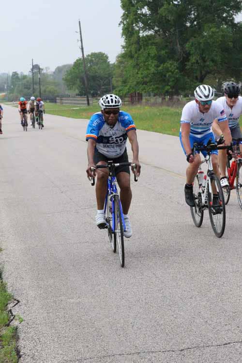 Riders participating in the Bluebonnet Express cycling event on a rural road.