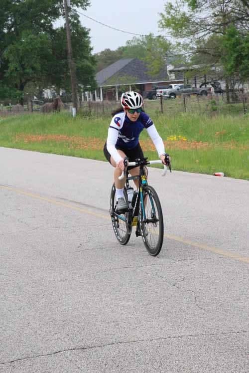 Smooth road cycling on Bluebonnet Express scenic route with cyclist in motion.